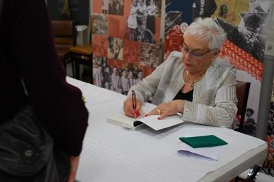 Freda Hodge signing copies of Tragedy and Triumph at the book launch