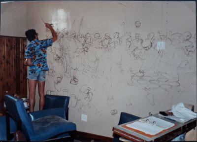 Michael Dams creating the mural in College House in 1982.