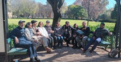 After the formal proceedings a few alumni lingered to chat under the trees next to the library lawns on campus.