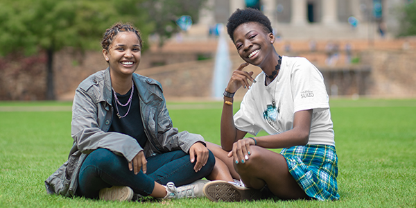 Two young women sitting on lawn