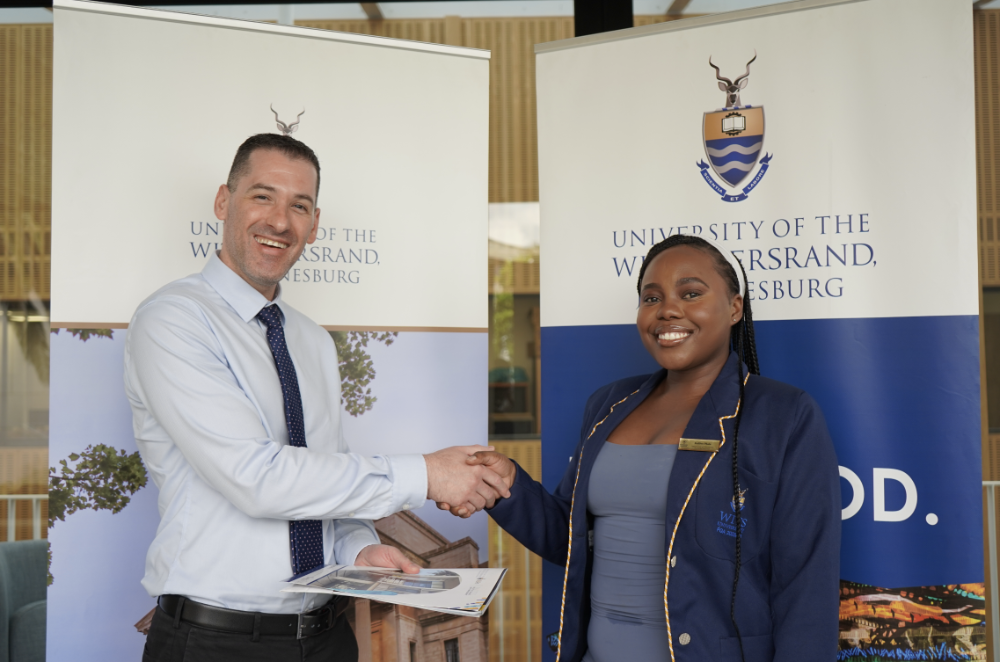 Dean of CLM, Professor Jason Cohen, shakes hands with PGA Faculty rep, Kefilwe Phala