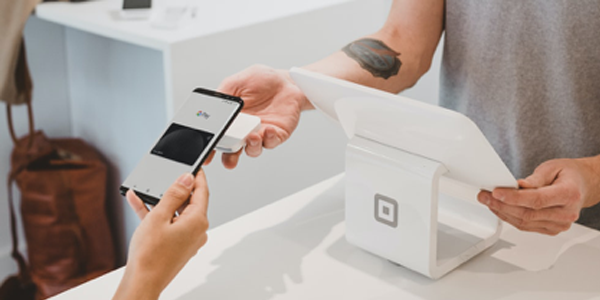 person holding phone to make payment