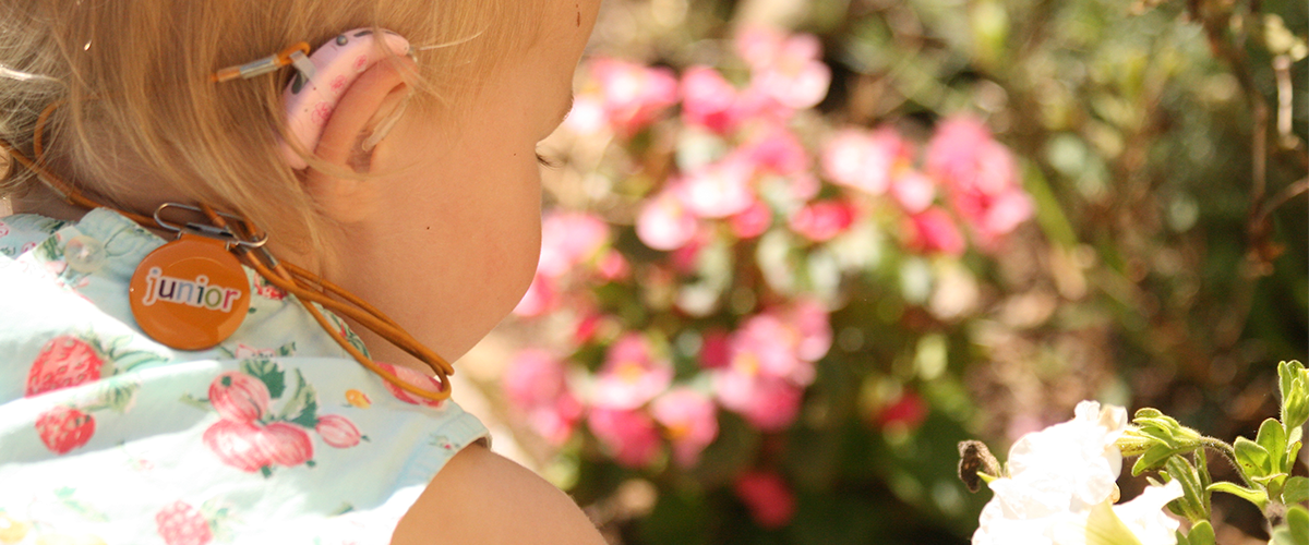 Toddler in garden with flowers