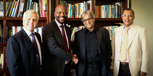 Absa Bank’s Dr Theunie Lategan and Mr Steven Seaka hand over a letter confirming Absa’s R10 million donation to Wits’ Professor Adam Habib and Dr Randall Carolissen.