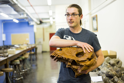 Dr Julien Benoit with the cast of a scull of a Dinocephalian.