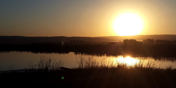 Sun rising over a lake