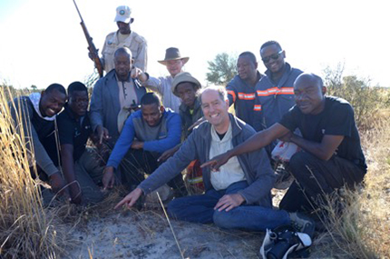 Search team pointing to the first meteorite found.