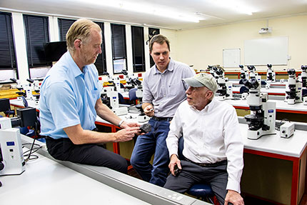 Professors Roger Gibson (left) and Lewis Ashwal (right) discussing their preliminary assessment of the Benenitra meteorite with Tim Marais. Credit: Wits University