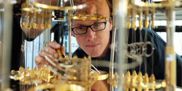 IBM scientist Stefan Filipp, takes a closer look inside the IBM quantum computer_© IBM