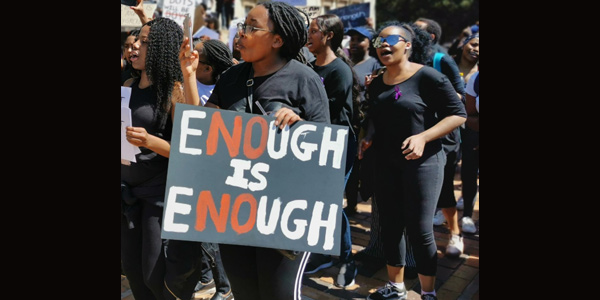 Student holding placard during  #AmINext march at Wits