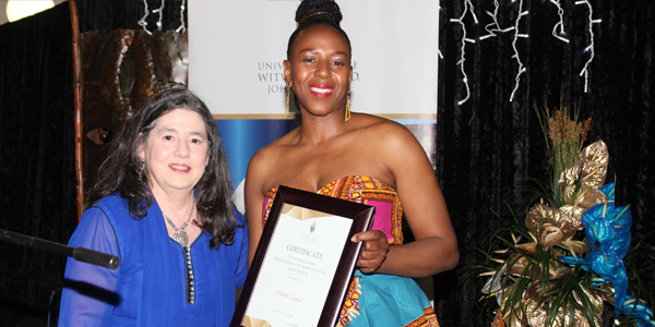 Professor Ruksana Osman handing over an award to Buhle Zuma from the Wits Communications Department.