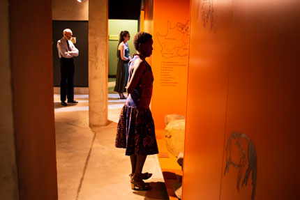 Guests enjoy a part of the exhibition at the opening of the rock art archive in the new wing of the Origins Centre at Wits University. Credit: Wits University