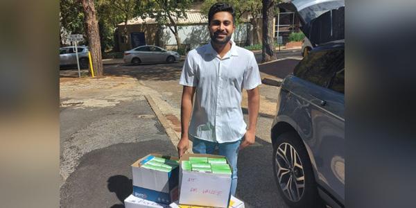 Wits Medical School graduate and first year intern doctor at Bara Naeem Vallee takes delivery of medical gloves against COVID19 donated by the Wits School of Molecular and Cell Biology
