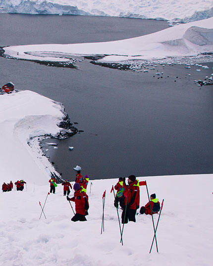 A tourist is seen visiting Hardy Cove in Antarctica. Hardy Cove forms part of the South Shetland Islands on the Antarctic Peninsula.