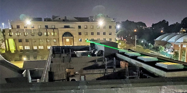 A laser beam shining from the window of the Optical Communications Laboratory at Wits University as part of a test bed. © Optical Communications Laboratory | WITS UNIVERSITY