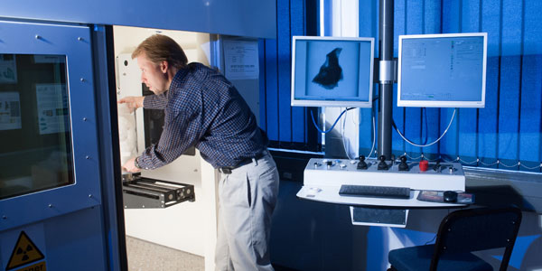 Professor Kris Carlson works on a MicroCT scanner at Wits University.