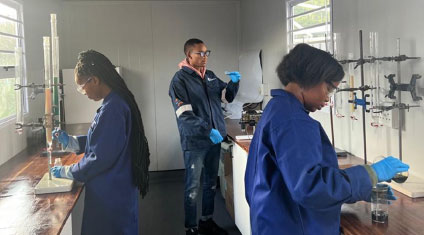 Researchers working at a containerized laboratory running column tests on acid mine drainage