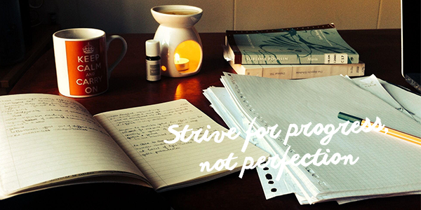 Image of notebook, coffee mug and books on desk