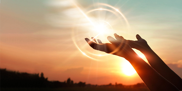 Hands with sun rays