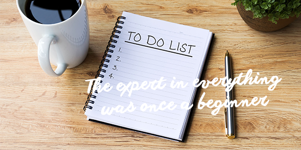 Note pad with words 'to do list' on desk Note pad with words 'to do list' on desk