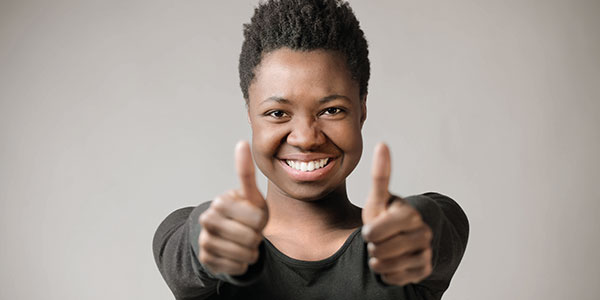 Young woman holding thumbs ups